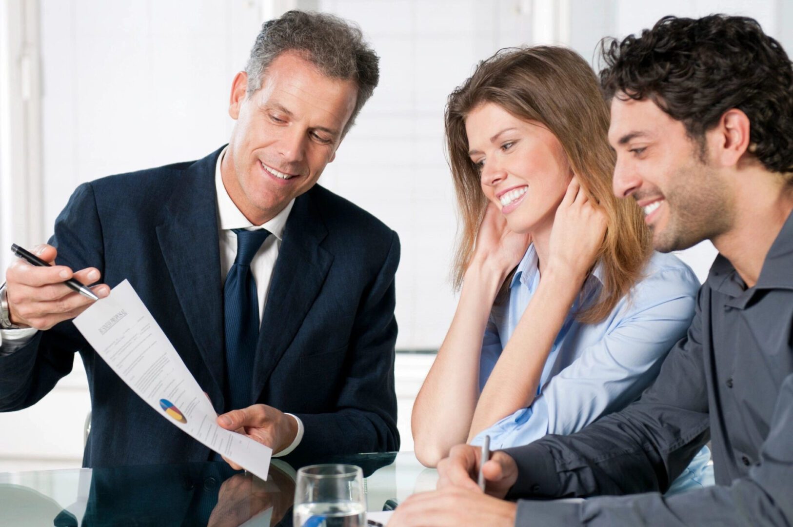 couple smiling while signing contacts