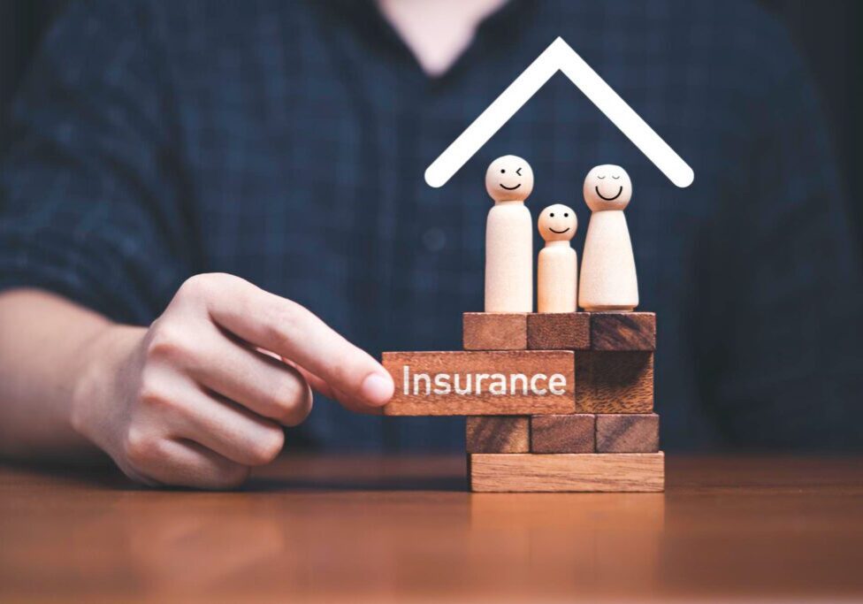 family-standing-wooden-block-with-hand-pulling-block-which-print-screen-insurance-it-assurance-life-asset-concept family-standing-wooden-block-with-hand-pulling-block-which-print-screen-insurance-it-assurance-life-asset-concept