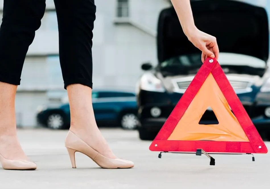woman-placing-emergency-sign